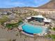 Aerial view of community pool, clubhouse, and playground with mountain views at 31489 N 126Th Ln, Peoria, AZ 85383