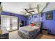 Stylish bedroom with tile floors, patio access, ceiling fan, and unique decorative touches at 3429 W Aire Libre Ave, Phoenix, AZ 85053