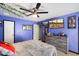 Cozy bedroom featuring tile floors, a ceiling fan, and creative decor, offering a comfortable retreat at 3429 W Aire Libre Ave, Phoenix, AZ 85053