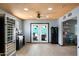 Bright kitchen featuring a wine refrigerator and a view of the backyard pool through French doors at 3429 W Aire Libre Ave, Phoenix, AZ 85053