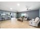 Open-concept living room featuring light wood floors, recessed lighting, and comfortable seating at 3429 W Aire Libre Ave, Phoenix, AZ 85053