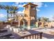 Resort-style pool area with a water slide, tower, lounge chairs, and beautiful landscaping for relaxation at 3749 E Riopelle Ave, Gilbert, AZ 85298