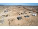 Wide aerial view of the homes in a desert community with nearby mountains in the distance at 37691 W Vermont Ave, Tonopah, AZ 85354