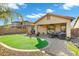 Great outdoor space with pavers, an artificial lawn, and mature landscaping to relax and enjoy at 3860 E Sundance Ave, Gilbert, AZ 85297