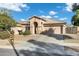 Inviting single-story home featuring a tile roof, arched entryway, and a spacious driveway at 3860 E Sundance Ave, Gilbert, AZ 85297