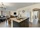 Open kitchen featuring a large island with a stainless steel sink and views into the dining and living areas at 3860 E Sundance Ave, Gilbert, AZ 85297