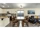 Bright kitchen with white cabinets and a decorative tile backsplash, open to the dining and living areas at 3860 E Sundance Ave, Gilbert, AZ 85297