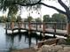 Picturesque lake scene featuring a wooden pier, calm water, and a bench for relaxing and enjoying at 3860 E Sundance Ave, Gilbert, AZ 85297