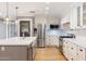 Bright kitchen featuring stainless steel appliances, white cabinets, a gray island with quartz countertop at 4623 E Pinchot Ave, Phoenix, AZ 85018