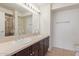 Bathroom featuring dual sinks with dark cabinets and a spacious walk-in shower at 4808 N 24Th St # 925, Phoenix, AZ 85016