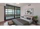 Bedroom featuring a large sliding glass door to the balcony and stylish decor at 4808 N 24Th St # 925, Phoenix, AZ 85016