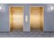 View of gold elevators with carpeted floors and wall sconces in a modern building at 4808 N 24Th St # 925, Phoenix, AZ 85016