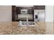 Close-up of a sink with stainless steel faucet and granite countertop, showcasing the modern kitchen features at 4808 N 24Th St # 925, Phoenix, AZ 85016