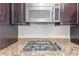Granite countertops accent the stainless steel gas cooktop and microwave in this modern kitchen at 4808 N 24Th St # 925, Phoenix, AZ 85016