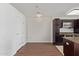 Bright kitchen area with a stainless steel oven and microwave, dark brown cabinets, and light hardwood floors at 4808 N 24Th St # 925, Phoenix, AZ 85016