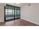 Bright living room with hardwood floors and glass doors to the balcony at 4808 N 24Th St # 925, Phoenix, AZ 85016