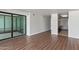 Living room area with sliding glass doors to a balcony, hardwood floors, and neutral wall colors at 4808 N 24Th St # 925, Phoenix, AZ 85016