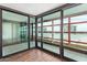 Bright living room with floor-to-ceiling windows offering city views and wood floors at 4808 N 24Th St # 925, Phoenix, AZ 85016