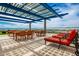Expansive rooftop deck with dining tables, lounge chairs, solar shades, and cityscape views at 4808 N 24Th St # 925, Phoenix, AZ 85016