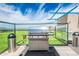 High-end rooftop BBQ area with stainless steel appliances, counter space, and secure glass perimeter at 4808 N 24Th St # 925, Phoenix, AZ 85016