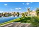 Tranquil backyard with waterfront view, mature trees, and manicured lawn at 4862 S Jojoba Way, Chandler, AZ 85248