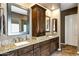 Bathroom featuring double sinks, granite countertops, tile floors, and framed mirrors at 4862 S Jojoba Way, Chandler, AZ 85248