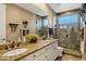 Bathroom featuring double sinks, granite countertops and a walk-in shower at 4862 S Jojoba Way, Chandler, AZ 85248