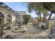 Secluded courtyard featuring a decorative water feature, comfortable seating, and mature greenery at 5478 E Oakhurst Way, Scottsdale, AZ 85254