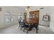 Elegant dining room featuring large windows, a classic chandelier, and a wood china cabinet at 5478 E Oakhurst Way, Scottsdale, AZ 85254