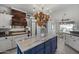Kitchen island with marble countertop, pot rack, wood accents and ample storage at 5478 E Oakhurst Way, Scottsdale, AZ 85254
