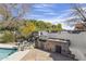 Outdoor kitchen featuring stone countertops, built-in grill, and a sink with a beautifully landscaped backdrop at 5478 E Oakhurst Way, Scottsdale, AZ 85254
