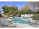 Sparkling swimming pool with a slide, surrounded by mature trees, landscaping, and a serene setting at 5478 E Oakhurst Way, Scottsdale, AZ 85254
