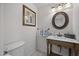 Charming powder room with vintage-style vanity, framed mirror, and soft lighting at 5478 E Oakhurst Way, Scottsdale, AZ 85254