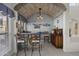 Custom wine cellar with barrel accents, arched stone ceiling, and comfortable seating area at 5478 E Oakhurst Way, Scottsdale, AZ 85254