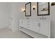 White bathroom vanity featuring double sinks, matte black lighting and hardware at 550 E Aurora Dr, San Tan Valley, AZ 85140
