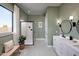 Spa-like bathroom featuring a glass-enclosed shower, modern vanity, and calming green walls at 550 E Aurora Dr, San Tan Valley, AZ 85140