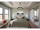 Well-appointed bedroom with a tray ceiling, chandelier, and natural light from a window at 550 E Aurora Dr, San Tan Valley, AZ 85140