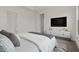 Bright bedroom featuring a modern entertainment center and stylish bedding at 550 E Aurora Dr, San Tan Valley, AZ 85140
