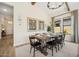 Elegant dining room featuring a farmhouse-style table, stylish black chairs, and natural light from a large window at 550 E Aurora Dr, San Tan Valley, AZ 85140