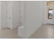 Hallway features light tile flooring with white walls and bright light from the front door at 550 E Aurora Dr, San Tan Valley, AZ 85140