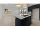 Bright, open kitchen with a large island, stainless steel appliances, and seamless living space at 550 E Aurora Dr, San Tan Valley, AZ 85140