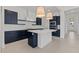 Bright, modern kitchen with navy blue cabinets, a center island, and elegant pendant lighting at 550 E Aurora Dr, San Tan Valley, AZ 85140