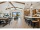 Bright open-concept living area with a dining space, a kitchen island, and sliding doors to the backyard at 550 E Aurora Dr, San Tan Valley, AZ 85140