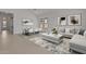 Bright living room features a comfortable sofa, stylish decor, and an elegant dining area with ample natural light at 550 E Aurora Dr, San Tan Valley, AZ 85140