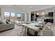 Open-concept living space featuring modern decor, a marble dining table, and a stylish kitchen with stainless steel appliances at 550 E Aurora Dr, San Tan Valley, AZ 85140