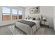 Comfortable main bedroom boasts ample natural light from three windows and cozy furnishings at 550 E Aurora Dr, San Tan Valley, AZ 85140