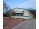 This single story home features turquoise trim, an awning over the windows, and a covered parking area at 685 Smoketree St, Wickenburg, AZ 85390