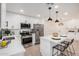 Modern kitchen with white cabinetry, stainless steel appliances, and pendant lighting over the breakfast bar at 709 N San Jose N Cir, Mesa, AZ 85201