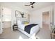 Bright bedroom featuring a ceiling fan, queen bed, modern art, and walk-in closet at 7175 E Rancho Del Oro Dr, Scottsdale, AZ 85266