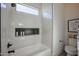 Elegant bathroom featuring marble tiled shower and tub, modern fixtures and herringbone tiled niche at 7195 E Rancho Del Oro Dr, Scottsdale, AZ 85266